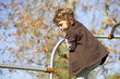 Little girl playing on climbing frame