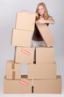 Woman stood by pile of cardboard boxes