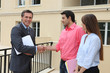 Couple shaking the hand of a real estate agent