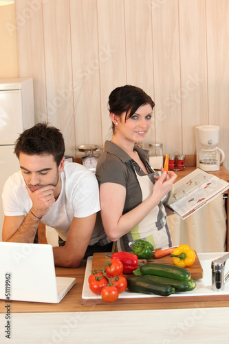Photo: Couple looking at recipes Couple looking at recipes