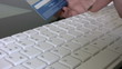Woman confirming credit card data for e-commerce.