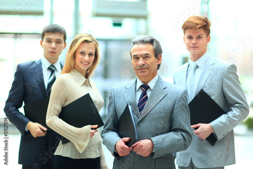 Photo: Group of business people with businessman leader Group of business people with businessman leader