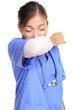 Sneezing woman medical nurse doing elbow sneeze