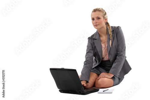 Photo: Businesswoman sitting on the floor with laptop Businesswoman sitting on the floor with laptop