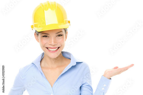 Photo: Hard hat engineer or architect woman showing Hard hat engineer or architect woman showing