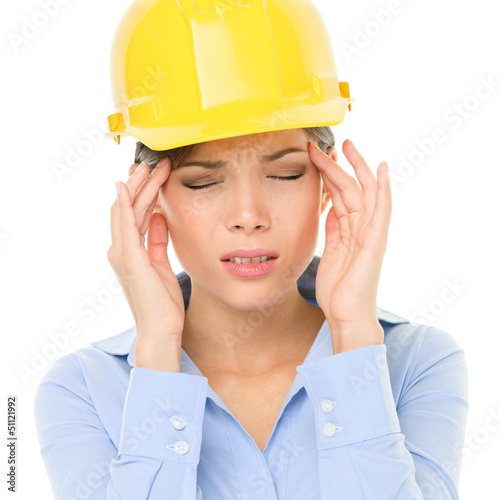 Photo: Engineer or architect woman worker headache stress Engineer or architect woman worker headache stress