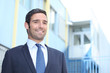 Smiling businessman outside a building