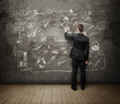 man drawing on grunge concrete wall