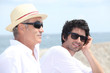 Grandfather and grandson in front of sea
