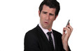 Businessman grimacing at his phone