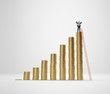 Businessman on the top of increasing columns of gold coins