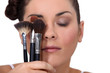 Woman holding various make-up brushes