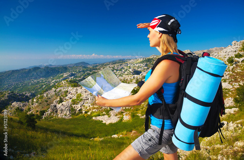 Photo: Active girl with map in the mountains Active girl with map in the mountains