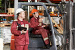 warehouse workers in front of forklift