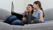 Two sister using a laptop in the living room