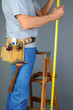 Photo: Contractor Standing on Ladder Measuring Contractor Standing on Ladder Measuring