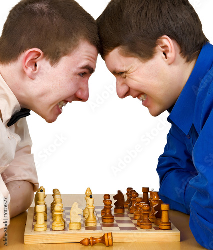 Photo: Two aggressive chess opponents under chess board Two aggressive chess opponents under chess board