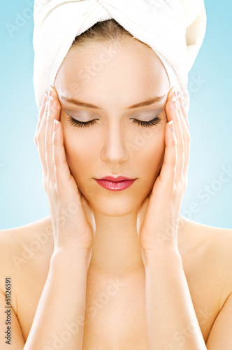 Photo: Beauty with towel isolated on blue Beauty with towel isolated on blue