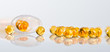 Capsules of fish oil spilled out open container