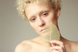 Young sexy girl with a dry leaf in hand