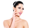 Photo: Beautiful expressive woman cares of the skin face Beautiful expressive woman cares of the skin face