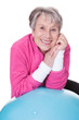 Senior Woman Leaning On Pilates Ball
