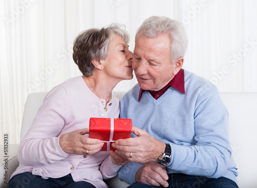 Photo: Senior Man Giving Gift To Senior Woman Senior Man Giving Gift To Senior Woman