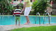 Video: Father with son by the hotel swimming pool, steadicam shot Father with son by the hotel swimming pool, steadicam shot