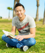 Photo: Man Holding Book In Park Man Holding Book In Park