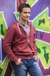 Style teen boy near graffiti background.