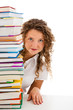 Young woman behind pile of books isolated on white background