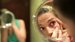 Video: Beautiful young woman checking her face in the mirror Beautiful young woman checking her face in the mirror