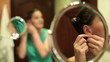 Video: Beautiful woman putting on earrings in bathroom Beautiful woman putting on earrings in bathroom