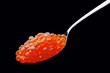 Photo: The spoon with red caviar on a black background The spoon with red caviar on a black background