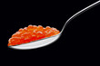 Photo: The spoon with red caviar on a black background The spoon with red caviar on a black background