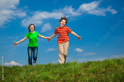 Photo: Girl and boy running, jumping outdoor Girl and boy running, jumping outdoor