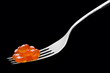 Photo: The fork with red caviar on a black background The fork with red caviar on a black background