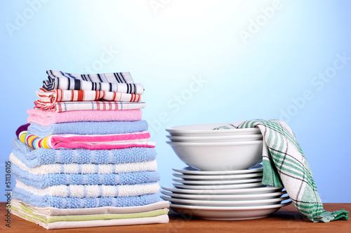 Photo: kitchen towels with dishes on blue background close-up kitchen towels with dishes on blue background close-up