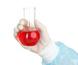 Glass tube with fluid in scientist hand during medical test