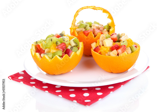 Photo: Fruit salad in hollowed-out orange isolated on white Fruit salad in hollowed-out orange isolated on white