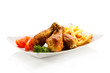 Grilled chicken drumsticks with chips and vegetables