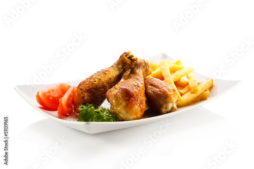 Photo: Grilled chicken drumsticks with chips and vegetables Grilled chicken drumsticks with chips and vegetables