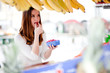 Young woman tasting raspberries at the market