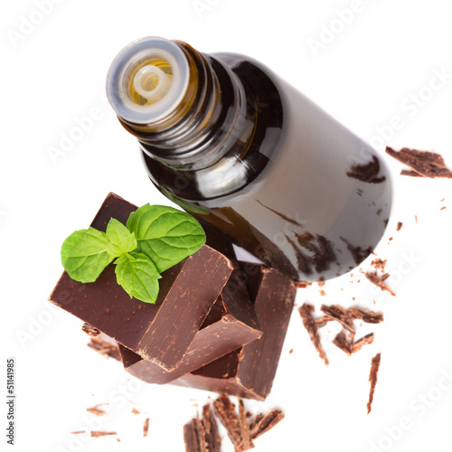 Photo: essential oil essential and chocolate with mint leaves isolated essential oil essential and chocolate with mint leaves isolated
