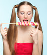 Young woman licking lollipop