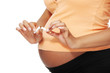 Pregnant woman breaking a cigarette