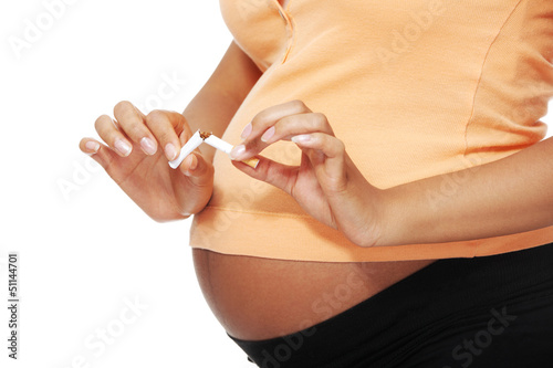 Photo: Pregnant woman breaking a cigarette Pregnant woman breaking a cigarette