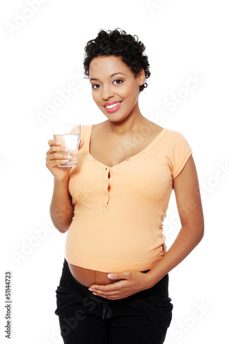 Photo: Pregnant woman with glass of water Pregnant woman with glass of water