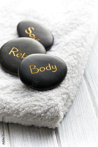 Photo: spa stones on white towel spa stones on white towel