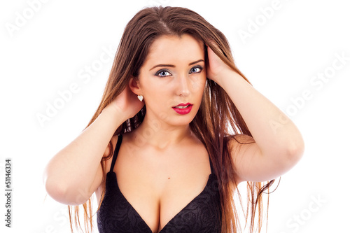 Photo: Beautiful young woman with hands touching her hair Beautiful young woman with hands touching her hair